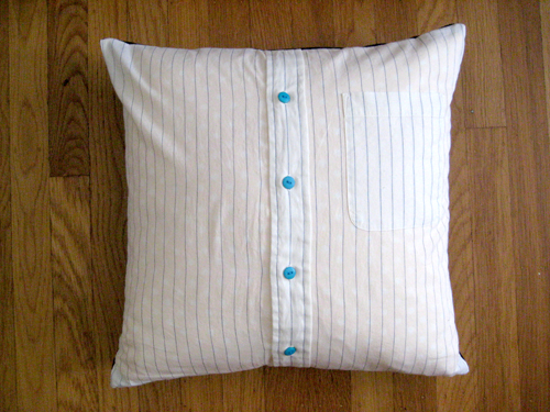  Striped men's shirt with blue buttons. Pillow cushion is lined with yellow and white polka dot fabric.